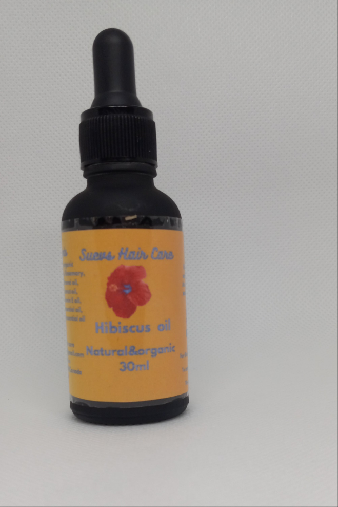 30ml Hibiscus-infused hair oil made with natural herbs and essential oils for healthy, shiny, and moisturized hair.
